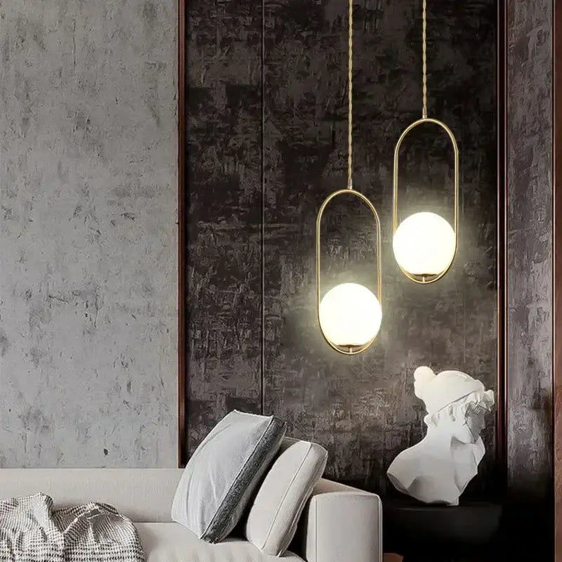 Minimalist gold-toned pendant lamp with frosted glass ball globes and twisted chain fixtures for dining room decorbites glass ball