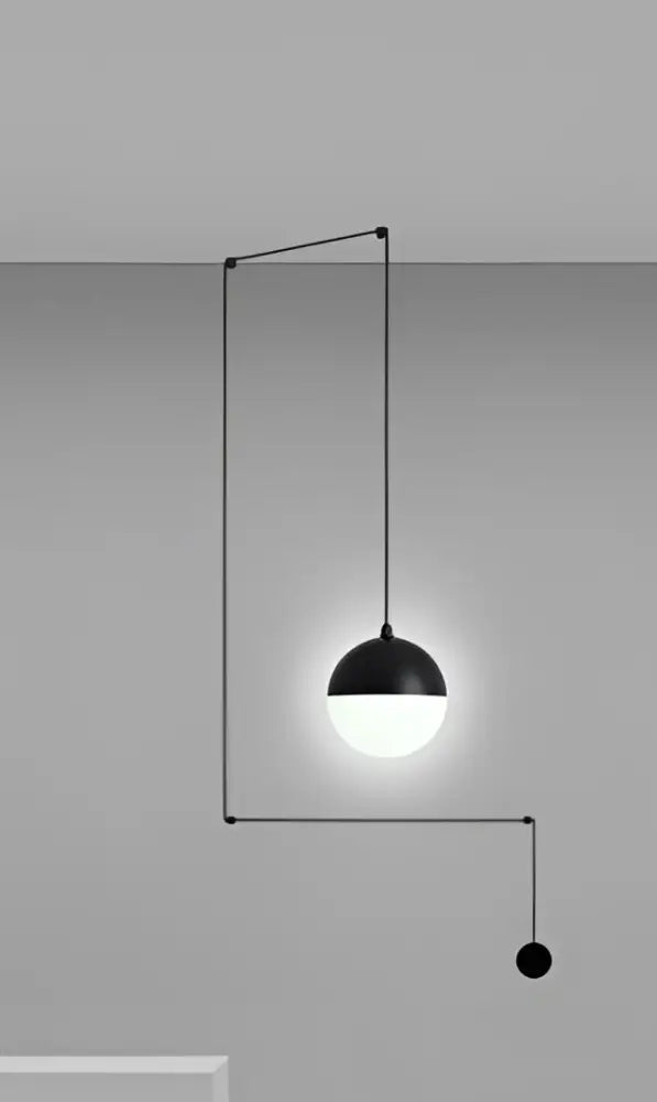 Minimalist black glass ball pendant light with glowing white bulb and geometric metal frame for kitchen decorbites glass ball