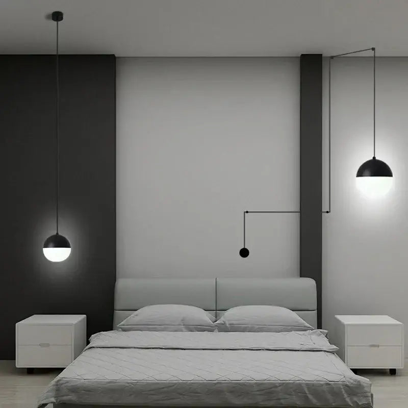 Minimalist black glass ball pendant light with sleek design hangs above bed in contemporary bedroom decorbites glass ball pendant