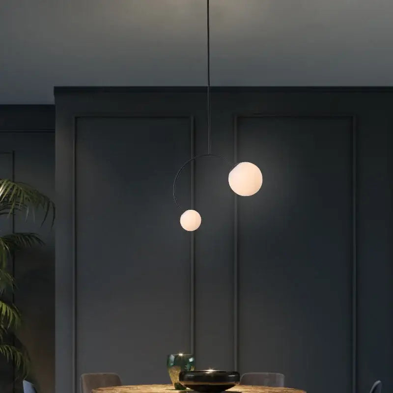 Minimalist black glass ball pendant lights with two frosted glass spheres suspended by thin black cord for dining room decorbites glass ball pendant