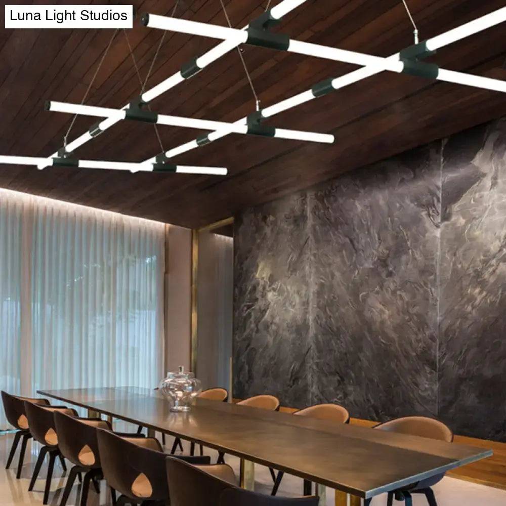 Modern geometric glass tube pendant lamp with white frosted shades and dark green connectors hanging from wooden ceiling