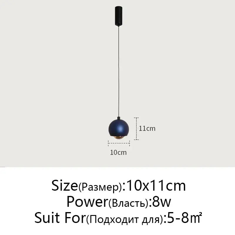A sleek spherical blue matte pendant light hangs from a black mount perfect for minimalist decorbites gold metal luster
