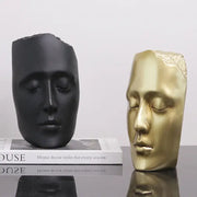 Minimalist black and gold abstract face sculpture featuring a matte black face and a polished golden mask for living room decor