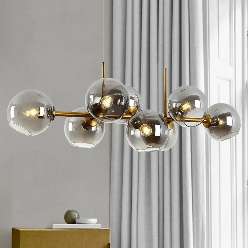 Minimalist black and gold clear smoke grey chandelier with brass and smoked glass globe for dining room lighting