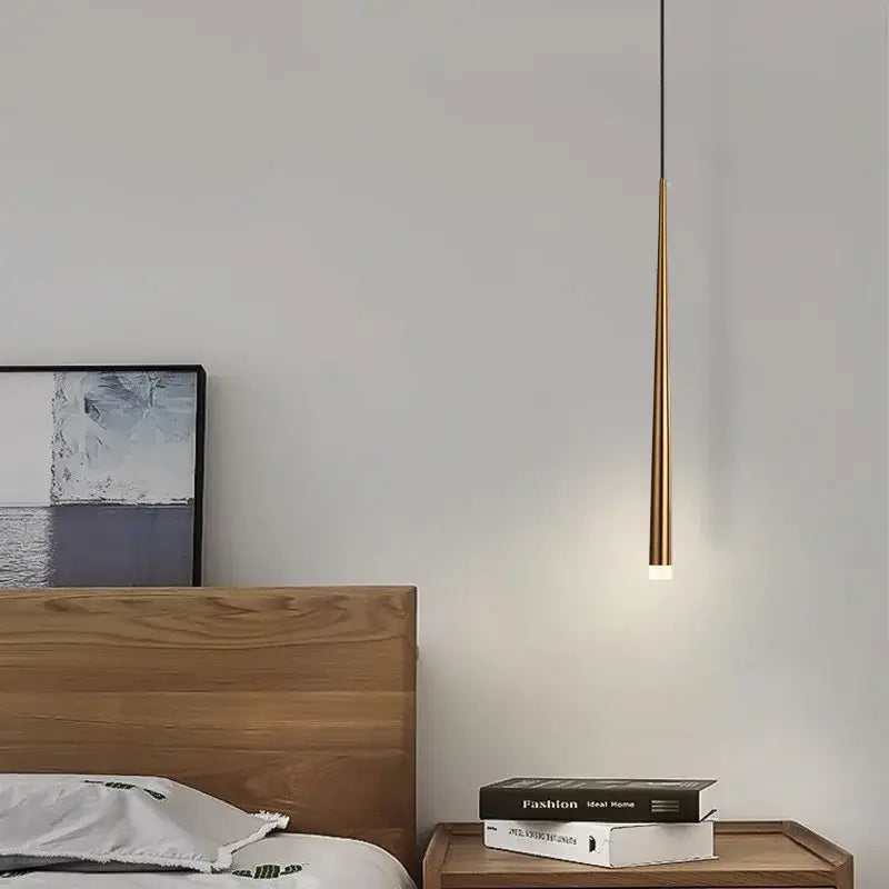 A sleek gold-toned decorbites cone tube pendant light with warm glow for kitchen and dining room decor