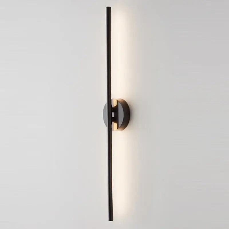 Minimalist black and gold copper wall sconce lamps with a sleek vertical bar and warm light for bathroom decorbites copper wall