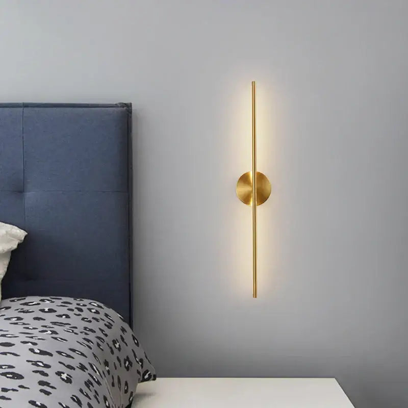 Minimalist black and gold copper wall sconce lamps with a gold-toned rod and warm light for bathroom decorbites copper wall