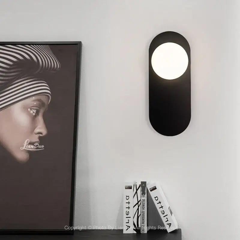 Black oval wall sconce with circular illuminated center minimalist black and gold decorbites glass ball led bedroom light