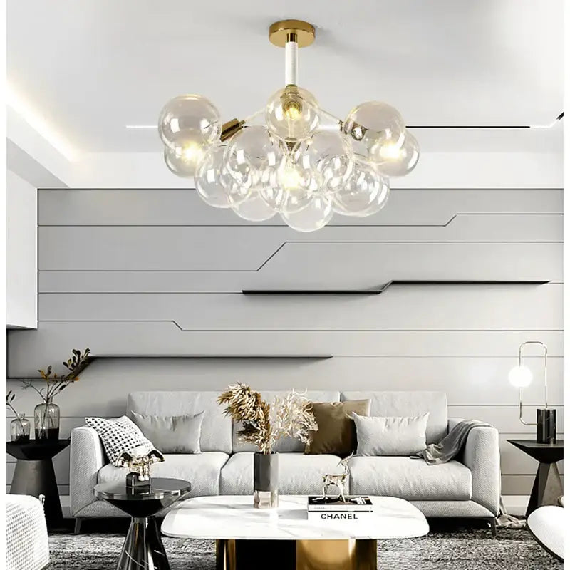 Minimalist black and gold glass balls ceiling pendant lights featuring a modern gold-toned chandelier with clear bulbs