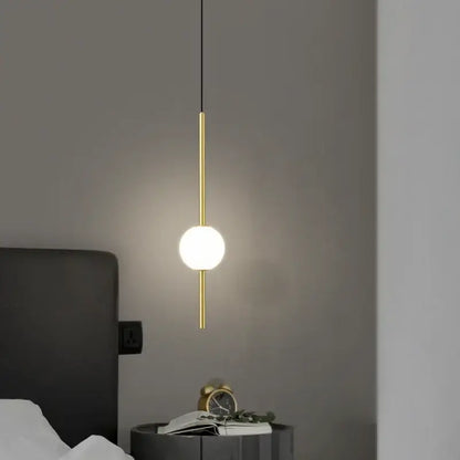 Minimalist black and gold globe pendant light with frosted glass shade and sleek metal rod for cord pendant installation