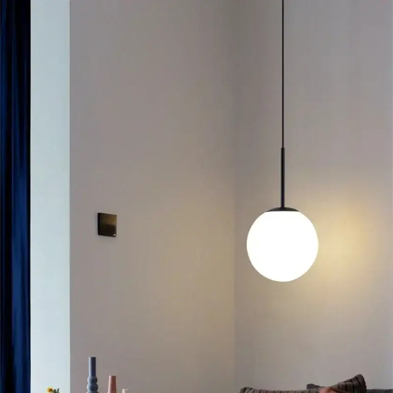 Minimalist black and gold pendant light with frosted glass globe and led bulb for kitchen lighting
