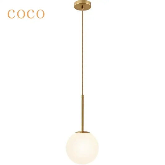 Gold-finished minimalist pendant light with sleek spherical frosted glass globe and LED bulb for kitchen use