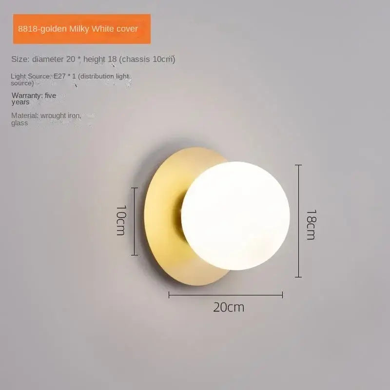 A modern led wall lamp with a golden wrought iron base and milky white glass globe for living room use