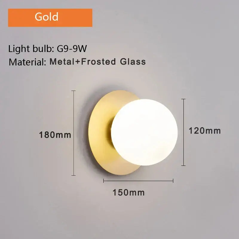 Minimalist black and gold led wall sconce with gold-toned metal base and circular frosted glass diffuser for bedroom lighting