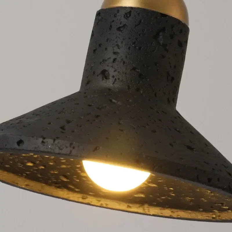 Minimalist pendant light with black travertine speckled concrete and gold-finished interior by decorbites black travertine led