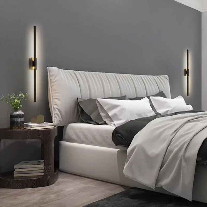 White tufted upholstered bed with gray bedding beside minimalist black nordic led vertical bar wall sconce decorbites black nordic