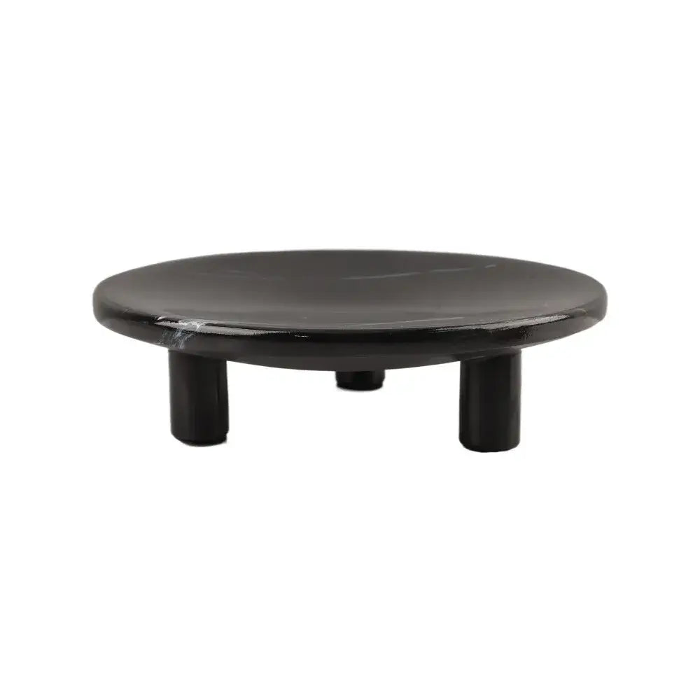 Black circular fruit tray with glossy imitation marble finish and three short cylindrical legs for dining room decorbites decor