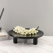 Minimalist black imitation marble fruit tray with two legs holding white faux grapes for dining room decorbites imitation marble