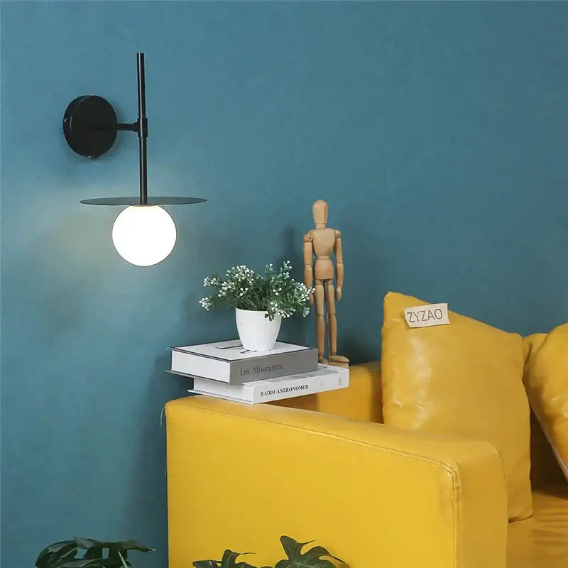 Minimalist black iron glass led wall light with circular base and frosted globe for bedroom living room decorbites wall light