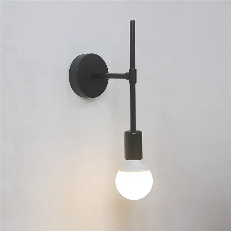 Minimalist black iron glass led wall light with sleek circular base and slender arm for bedroom and living room decorbites wall light
