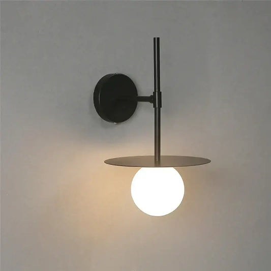 Minimalist black iron glass led wall light with matte metal arm and warm-glowing bulb for bedroom living room decorbites iron glass