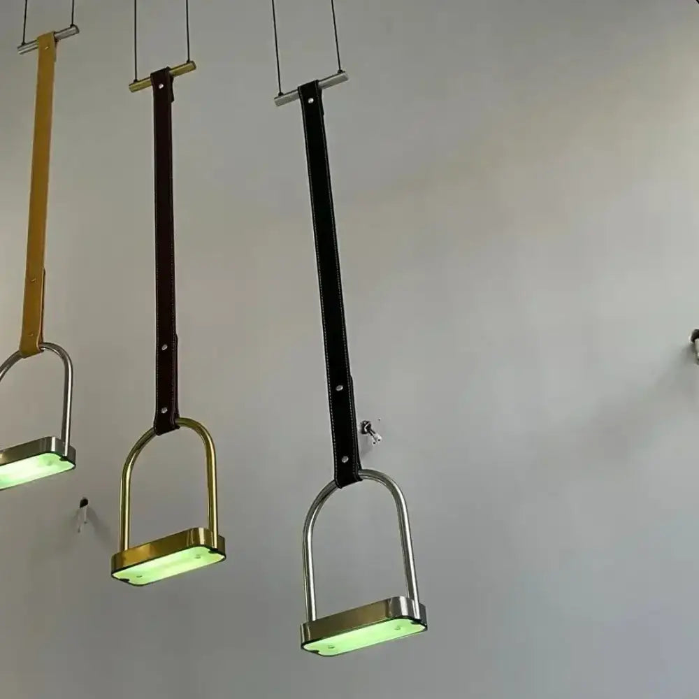 Minimalist black leather belt pendant light featuring tan brown and black straps with metallic frames for decorbites art minimalist living room decor