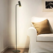 Minimalist black enna led dimmable floor lamp with slender metal stand and circular base emitting warm light for living room