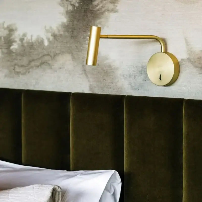 Gold-finished wall-mounted reading lamp with sleek articulated arm complements minimalist black enna led dimmable floor lamp
