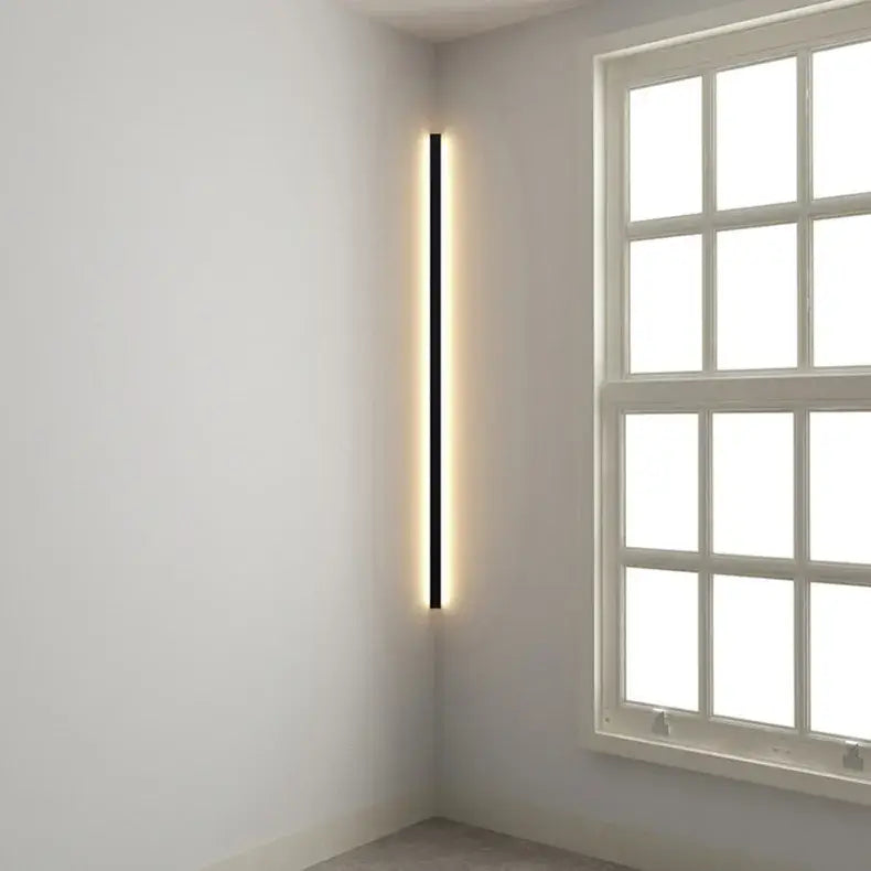 A sleek black minimalist led wall lamp with a warm glowing strip for bedroom and living room lighting