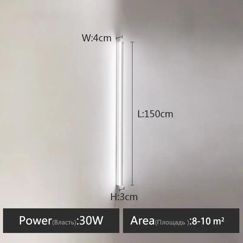 A sleek minimalist black linear led wall lamp with slim white cylindrical body providing warm glow for bedroom wall