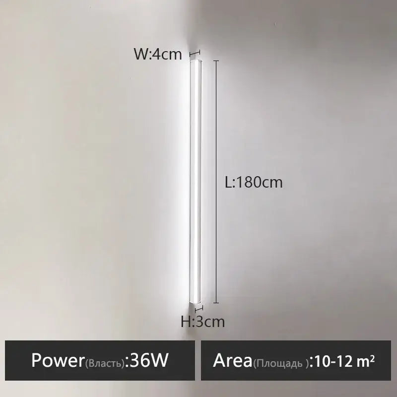 A sleek minimalist black linear led wall lamp with a slim white cylindrical design for a warm bedroom wall glow