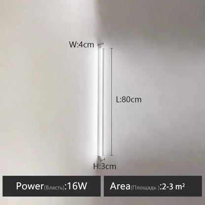 A sleek white led wall lamp with a slim cylindrical design 80cm long for a minimalist bedroom wall warm glow