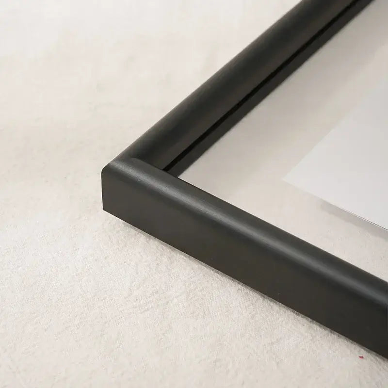 Black matte-finished minimalist mademoiselle hangable picture frame corner with sleek modern design for bedroom art