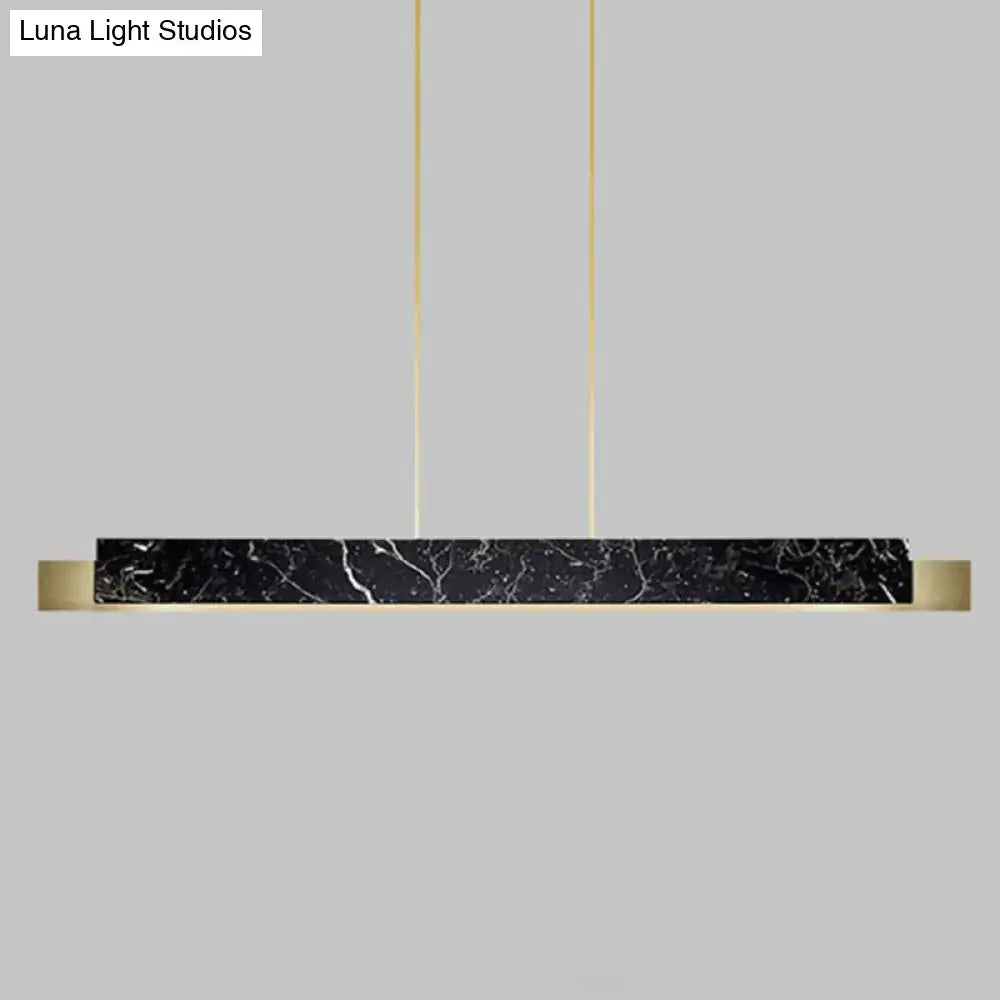Minimalist black marble rectangular dining room light with gold accents and black cord hanging cords