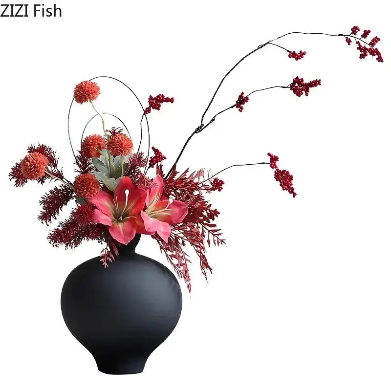 Black matte big belly ceramic vase holding vibrant artificial flowers and berries for living room decor