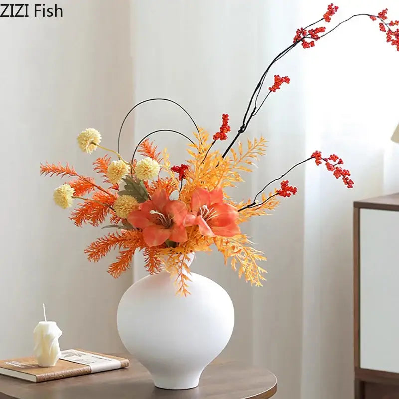 White big belly ceramic vase with vibrant autumnal artificial flowers for minimalist living room decor