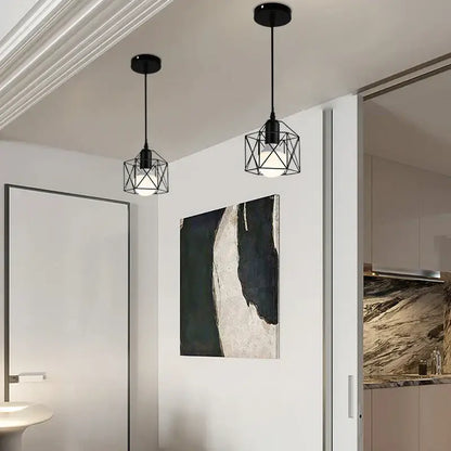 Minimalist black metal pendant light with geometric wireframe cage design and exposed bulbs for kitchen use