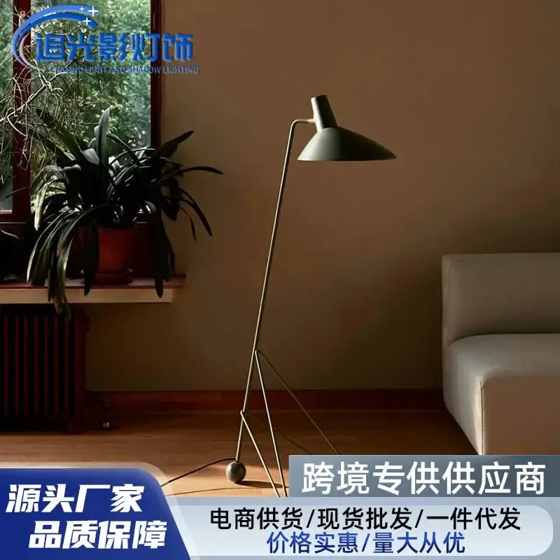 Minimalist tripod desk lamp with a matte dark green conical shade and slender black metal frame for office or bedroom