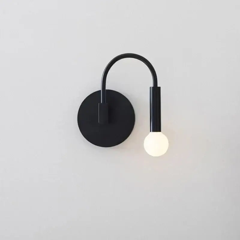 Minimalist black modern wall lamp with curved arm and spherical bulb for bedroom decorbites black modern wall design