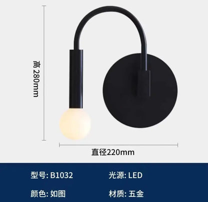 Minimalist black modern wall lamp with curved arm and circular base featuring an led bulb for bedroom decorbites black modern design