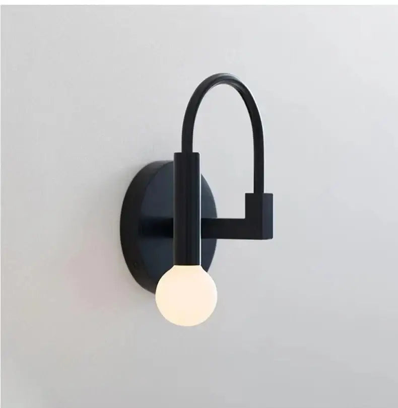 Minimalist black modern wall lamp with curved arm and spherical bulb for bedroom decorbites black modern wall lighting