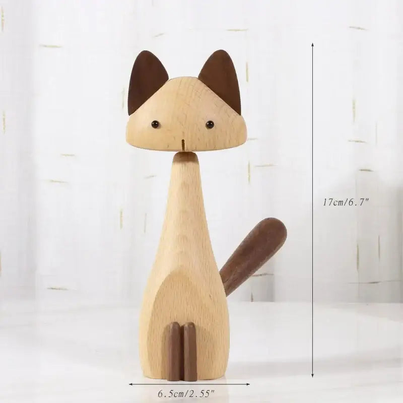 Minimalist black and natural wood carving figurines showing a wooden cat with dark ears and tail for living room decor