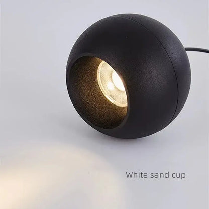 Minimalist black spherical pendant light with warm glow featuring die-cast aluminum and acrylic lamp holder for kitchen use