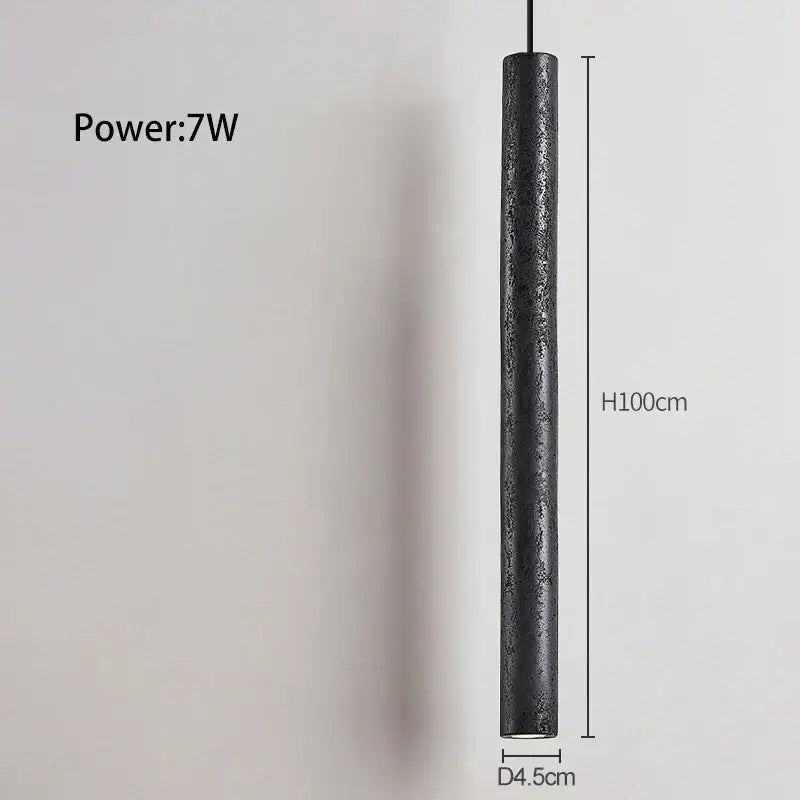 A sleek matte black stone tube led pendant light with textured surface 100cm height 4.5cm diameter decorbites black stone