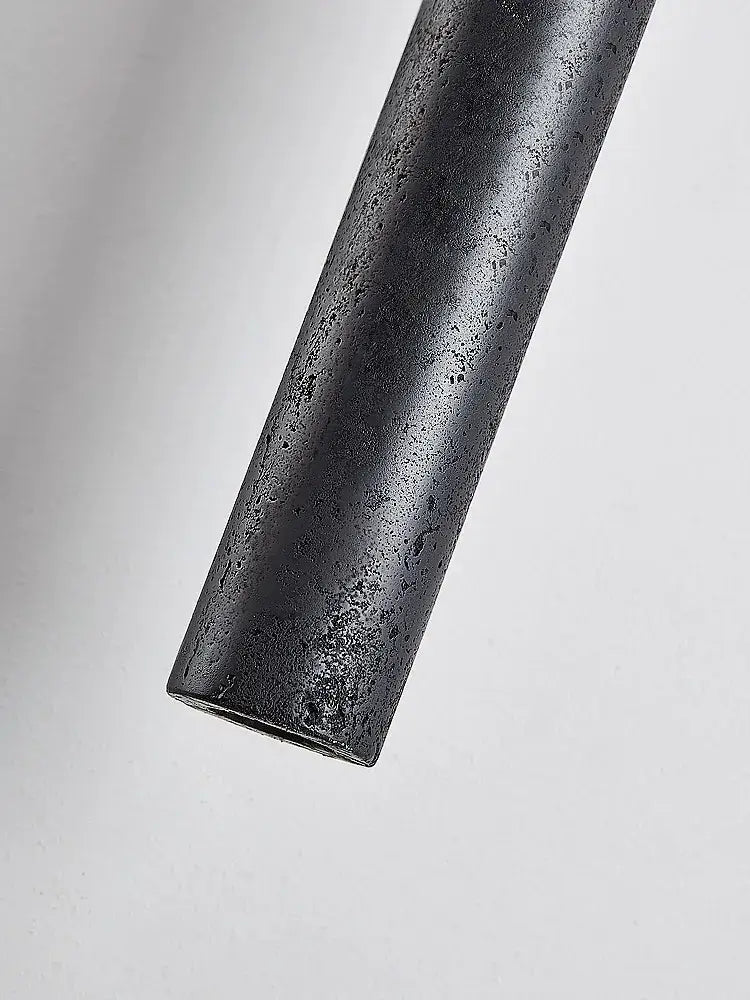 Minimalist black stone tube led pendant light with matte textured finish for bedroom lighting by decorbites black stone