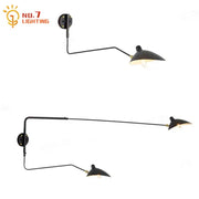 Minimalist black metal wall lamp with two adjustable arms designed for bedroom decorbites dawn spider serge lighting