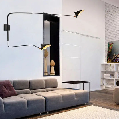 Minimalist black two arm wall lamp with articulated arms and gold-toned shades for bedroom decorbites dawn spider