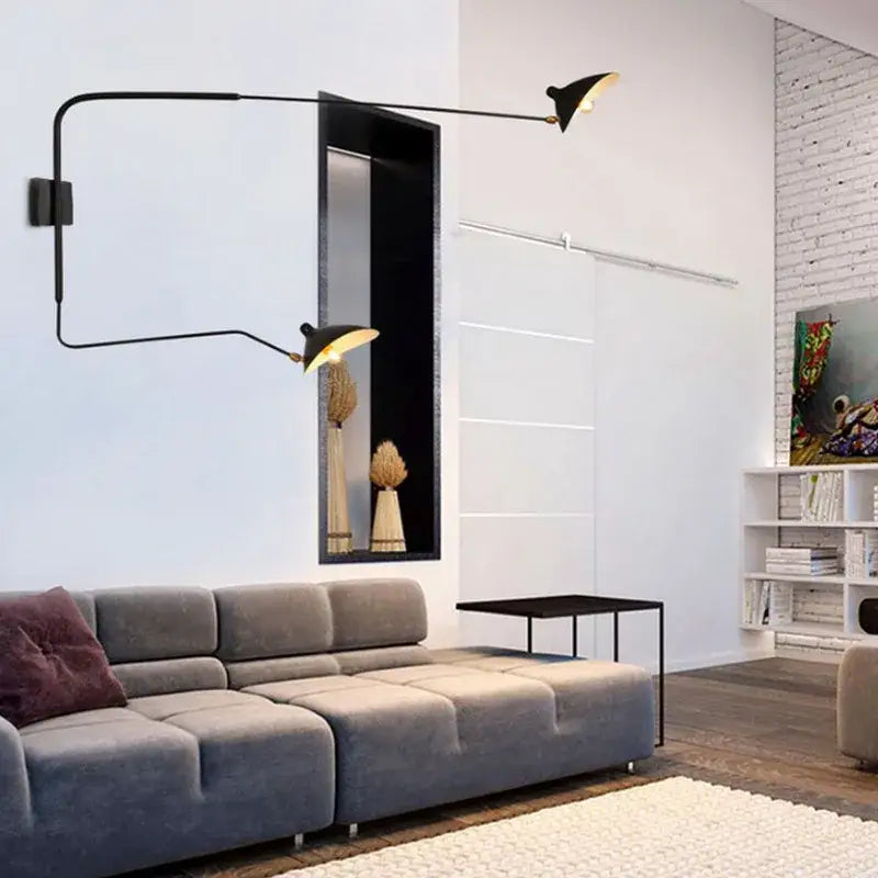 Minimalist black two arm wall lamp with articulated arms and gold-toned shades for bedroom decorbites dawn spider