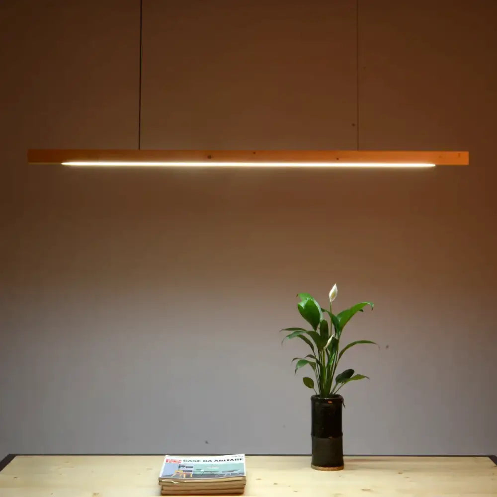 Minimalist black walnut log pendant light with warm linear glow for dining room decorbites black walnut design