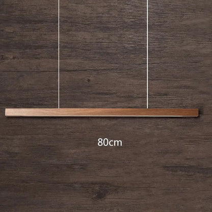 Minimalist black walnut log pendant light with sleek rectangular design and natural wood grain finish for dining room decor